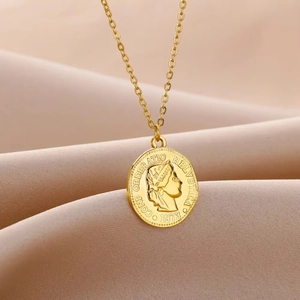 Detail of gold coin necklace with embossed profile and vintage 1973 lettering on silk