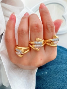 Close-up of three 18K gold plated rings stacked on a hand for a trendy layered look