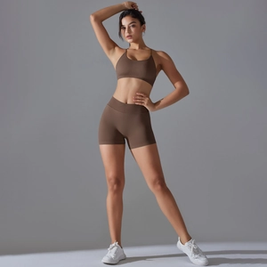 Detail of seamless brown yoga set showing high-elastic fabric and cross-back sports bra
