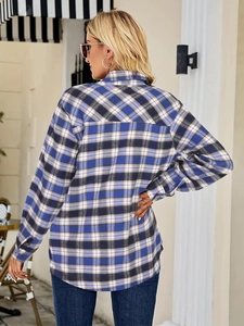 Outdoor back view of a blue and yellow plaid long sleeve button-down shirt for women