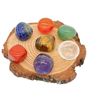 Polished seven chakra natural crystal stone set on rustic wood base for healing