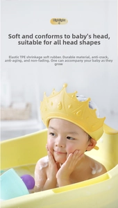 Macro detail of the yellow crown baby bath cap showing elastic TPE material on a toddler