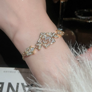 Close-up of elegant gold flower bracelet with sparkling zircons and adjustable sliding clasp