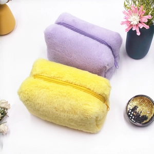 Set of soft plush makeup bags in purple and yellow candy colors with secure zippers