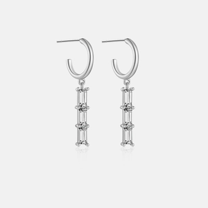 Detail view of 925 sterling silver hoop earrings with triple rectangular zircon stones