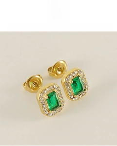 Close-up of emerald-cut green gemstone earrings with white diamond halo in 18K gold plating