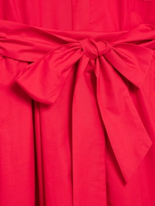 Detailed view of the elegant red poplin dress featuring a stylish waist tie bow design