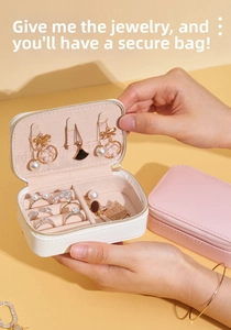 Detailed interior of a portable cream leather jewelry box with ring slots and necklace hooks