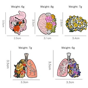 Cinq épingles en émail créatives avec organes anatomiques et motifs floraux et papillons