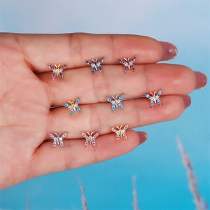 Detailed macro view of colorful butterfly stud earrings with marquise gemstones and diamonds
