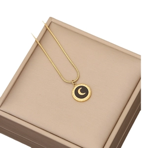 Elegant gold-tone moon pendant necklace with black inlay on minimalist snake chain