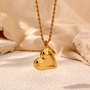 Elegant gold stainless steel heart pendant necklace with rope chain on neutral background