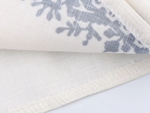 Detailed close-up showing overlock stitching and high-quality off-white fabric texture