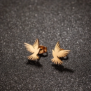 Retro golden stainless steel bird stud earrings featuring detailed wing texture for women