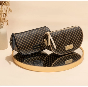 Detail of printed geometric saddle bags in black and brown on a gold mirror tray