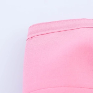 Macro shot of precise stitching and textile texture on the pink bow tube top fabric