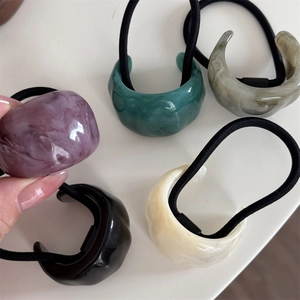 Five minimalist resin hair ties with marble pattern C-shape accents in mixed colors