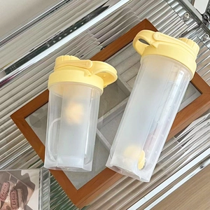 Set of two yellow PP plastic shaker bottles with scale for protein shakes and fitness