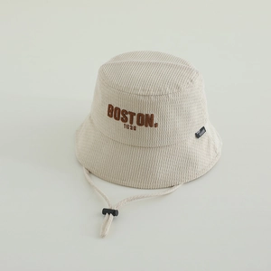 Detailed macro view of BOSTON 1630 embroidery on beige corduroy kids bucket hat