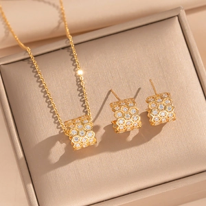 Golden honeycomb jewelry set with sparkling crystals in a premium beige gift box