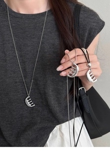 Detailed view of silver comb pendant necklace with different chain options and leather cord