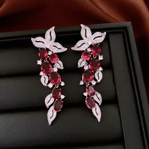 Luxury vintage leaf zircon tassel earrings with red gemstones on black jewelry box