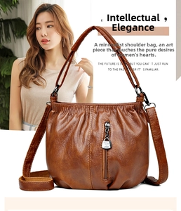 Detail of caramel pleated leather handbag featuring JPDS silver hardware and zippers