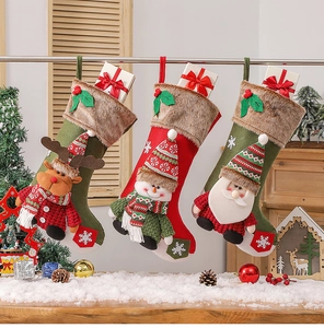 Hanging Christmas stockings with 3D Santa, Snowman and Reindeer on warm wood background
