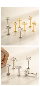 Detailed view of titanium labret studs with cubic zirconia flower and leaf designs