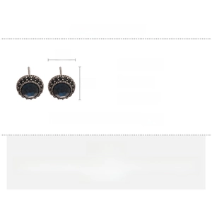 Macro detail of vintage round stud earrings featuring dark blue stones and black zircon