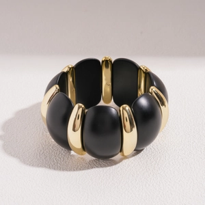 Detail of wide stretch bracelet with matte black resin and gold metal geometric links