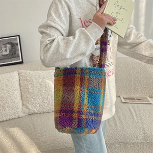 Detailed close-up of a colorful checkered lamb wool bucket bag worn over the shoulder