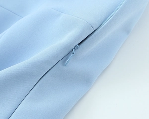 Close-up of the light blue concealed zipper detail and fabric texture on the top