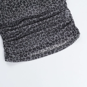 Detail view of leopard print mesh fabric with ruched design and stitching craftsmanship