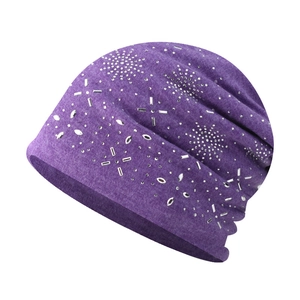Close-up of purple knit beanie featuring intricate silver rhinestone star patterns