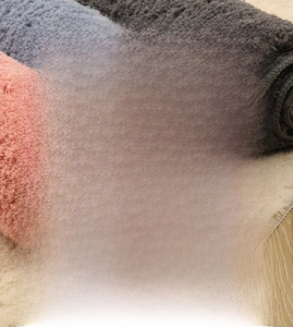 Detail view of high-density fiber texture and non-slip backing on thick bathroom mats