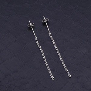 Elegant silver stainless steel long chain tassel earrings on black textured leather