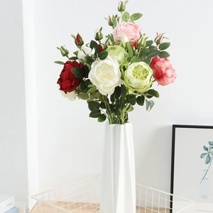 Close-up of colorful faux gypsophila bouquet in a modern geometric ceramic vase