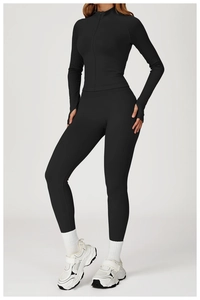 Detail of slim-fit yoga jacket with stand collar and thumbhole sleeves in black fabric