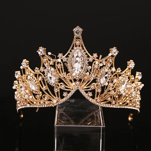 Elegant gold bridal crown featuring marquise crystals and white beads on a black background