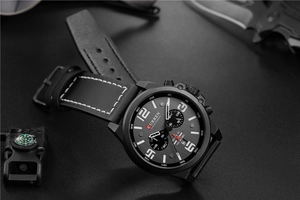 Tactical scene showing details of the black leather strap and chronograph watch dial