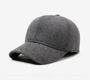 Close-up of dark grey wool blend baseball cap showing fleece lining and metal shield emblem