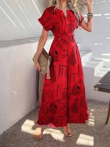 Detail of red floral print v-neck jumpsuit with buttoned waist and linen texture fabric
