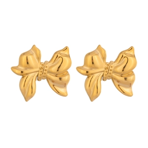Detailed close-up of golden bow-shaped stud earrings with intricate embossed textures