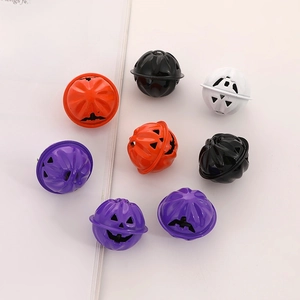 Close-up of Halloween metal bells featuring pumpkin faces in orange, black, and purple