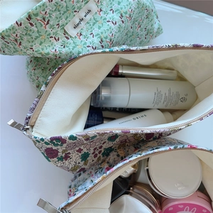 Detail view of the spacious floral cotton toiletry bag interior showing large storage capacity