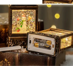 Detail of vintage Christmas lantern base showing the battery compartment and on-off switch