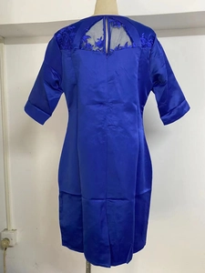 Detailed back view of a dark blue dress showing elegant hollow lace patchwork design