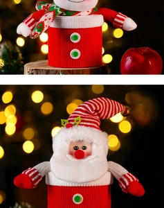 Detail of Christmas Santa and snowman knitted candy jars with warm bokeh background lights
