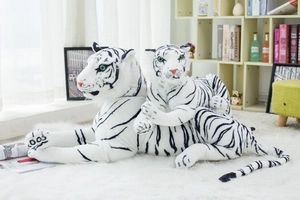 Detailed view of plush white tiger toys with black stripes on a white rug